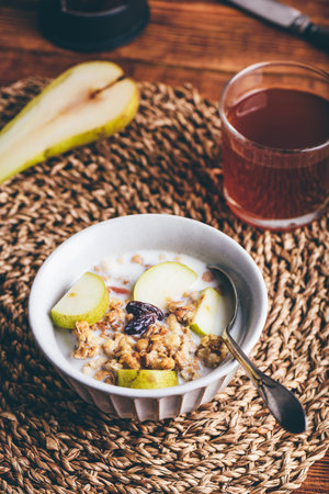 Close-up of Bowl with Delicious Granola and Fresh Pearの写真素材