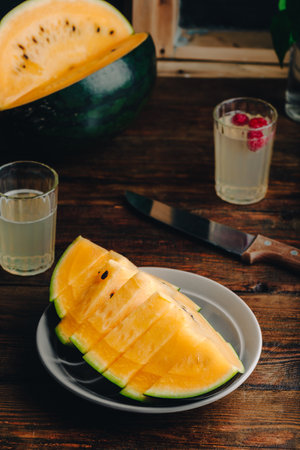 Sliced Yellow Watermelon on a Wooden Tableの写真素材