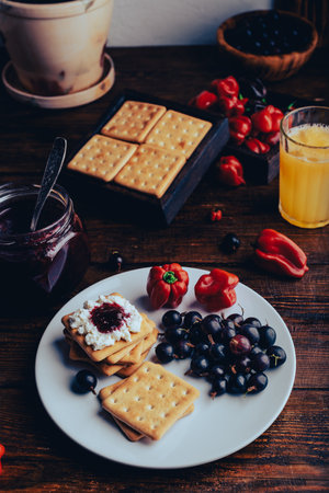 Crackers with Gooseberry and Red Habanero Pepper Jam and Ricotta Cheeseの写真素材