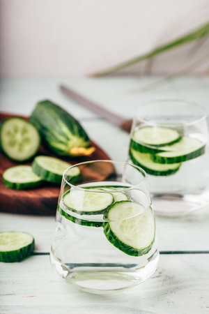 Detox water with sliced cucumber in a drinking glassの写真素材