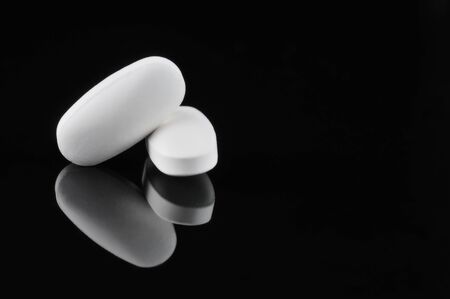 Pills isolated on black backgroundの写真素材