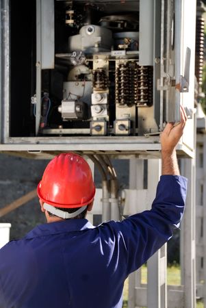 Electrician inspecting wires in electric panel 