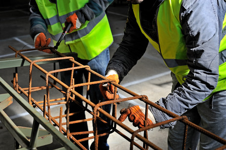Closeup shot on hands fixing steel reinforcement bars 