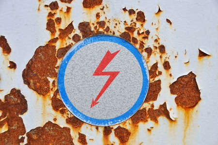 High voltage sign on rusty metal の写真素材