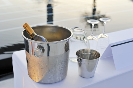 Bottle of wine glasses and pool preparing for partyの写真素材