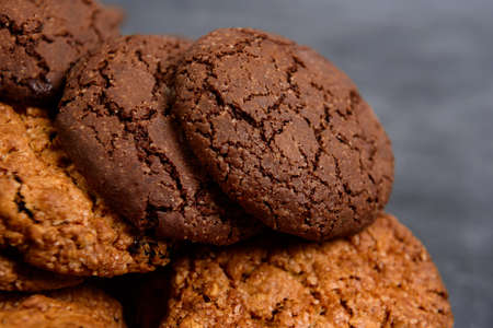 Sweet oatmeal and chocolate cookies on wooden tableの写真素材