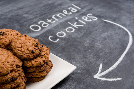Sweet oatmeal cookies  in plate on wooden table