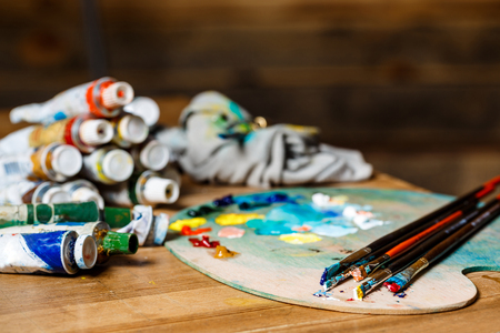 Close up photo of oil paints and brushes on palette. Copy space.の写真素材