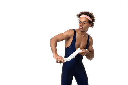 Young handsome sportive african man posing with towel over white background. Copy space.の写真素材