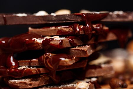Close up photo of chocolate and nuts over black background.の写真素材