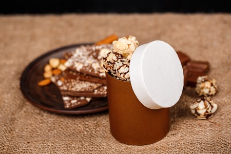 Chocolate nuts and cinnamon on sackcloth. Copy space.の写真素材