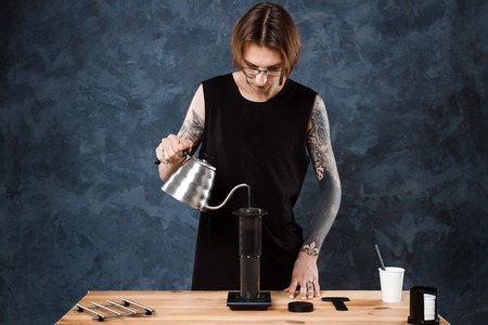 Male barista brewing coffee. Alternative method aeropress.の写真素材