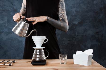 Male barista brewing coffee. Alternative method pour over.の写真素材