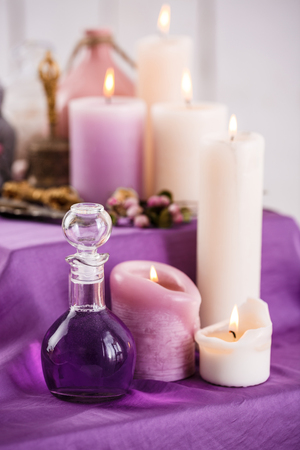Bottles with essential aroma oil and aroma candles.の写真素材