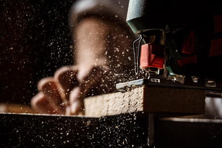 Close up photo of cutting wood with fretsaw.の写真素材