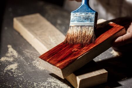 Close up photo of painting wood in brown color.