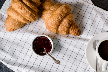 Picture of croissants on plates and coffee on grey table. Macro.の写真素材
