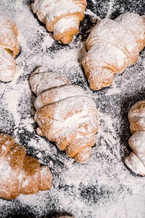 Picture of croissants with powdered sugar on grey table. Macro.の写真素材