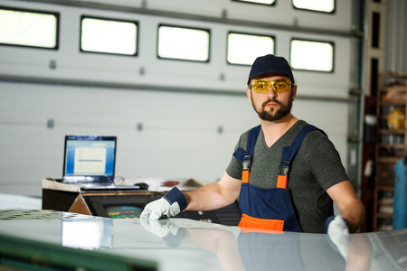 Portrait of worker in overalls, steel factory background.の写真素材