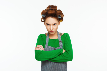 Young frustrated housewife cleaning on whiteの写真素材