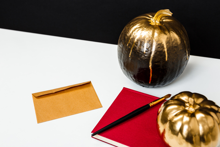 Halloween decor on white table over black background.の写真素材