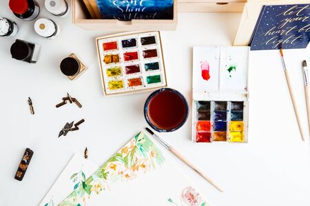 Watercolor paints brushes art details over white background.の写真素材