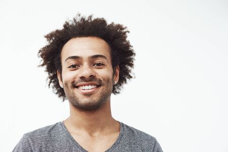 Happy african man smiling looking at camera. White background. Copy space.の写真素材