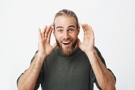CLose up portrait of handsome bearded man with stylish hairstyle playing with newborn baby...