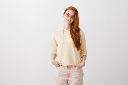 Expressing her bright soul with fashion. Portrait of attractive young european redhead in stylish...