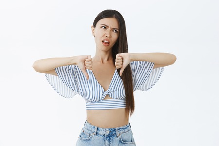 Portrait of arrogant displeased and unimpressed good-looking stylish woman sticking out tongue from...