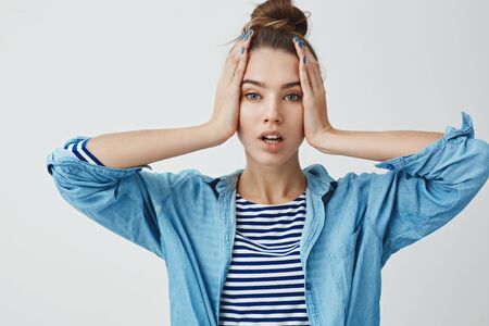 Glamour attractive modern young stylish 25s woman good skin, holding hands face open mouth sensually looking camera emotional concerned, forgetful, forget take out chicken oven, white backgroundの写真素材