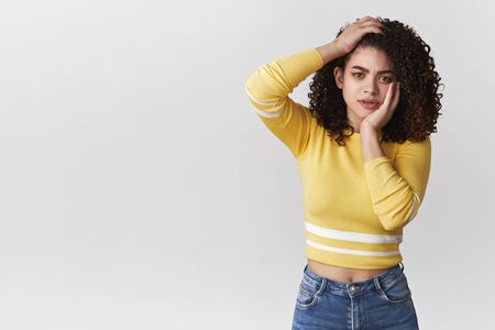 Puzzled worried nervous young cute female have problem standing, holding head