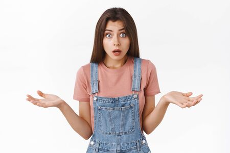 Confused shocked woman gasping troubled, explaining something or receive bad news, spread hands...
