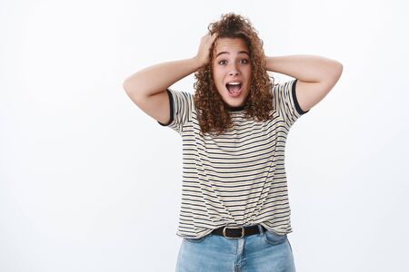 Surprised shocked excited charming young plump female student receive awesome unexpected news hold...