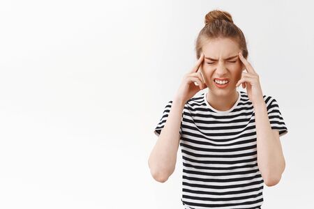 Girl cant concentrate, having huge headache, suffering migraine, squinting from pain close eyes and...