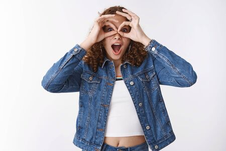Speechless excited astonished emotive cute curly-haired young girl drop jaw gasping amazed make...