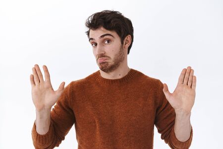 will deal with it. Confident and unbothered handsome 25s guy with beard, pouting and raise hands up, agree with someone lost argument and accept person opinion, white backgroundの写真素材