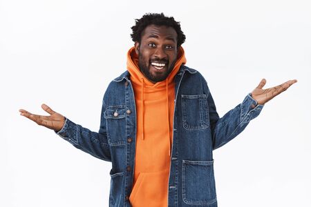 Carefree unbothered cool stylish african-american bearded man, spread hands sideways relaxed and...
