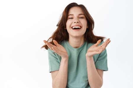 Beauty and skin care. Pretty teenage girl with natural nude make up laughing and showing candid...