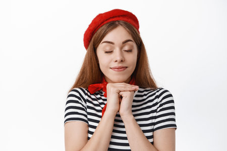 Dreamy and romantic girl wearing red beret, thinking or imaging something beautiful, picturing...