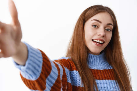 Close up of young woman taking selfie on mobile phone, stretch hand to hold smartphone camera and...