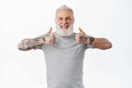 Nice choice, very good. Smiling old man shows thumbs up and looks happy and proud, praise great...