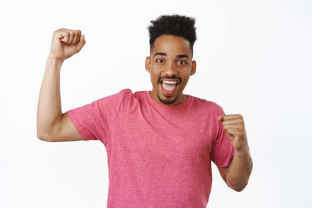 Portrait of excited african american guy chanting, sport fan cheering, rooting for team, celebrating...