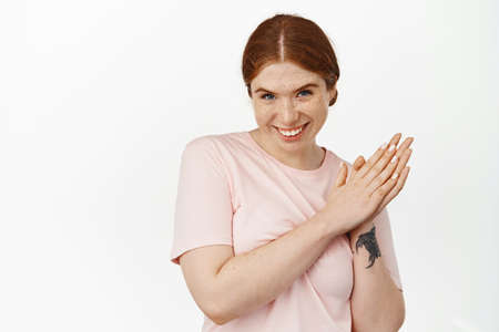 Image of young cunning redhead girl relish profit, rubbing hands and smiling devious, prepare plan,...