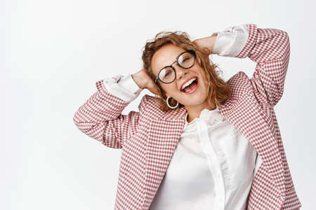 Portrait of happy young female entrepreneur, businesswoman looking carefree, laughing and smiling,...
