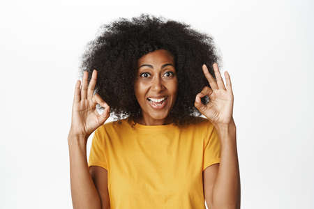 Close up portrait of african woman shows okay,ok sign, confirms smth, praise good work, recommends...