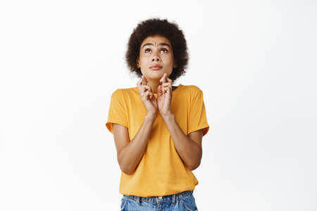 Hopeful african girl makes wish, praying and begging god, waiting for news, anticipating results,...