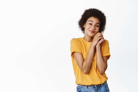How lovely. Cute African girl looking with yearning and admiration, dreamy smile, contemplating smth...
