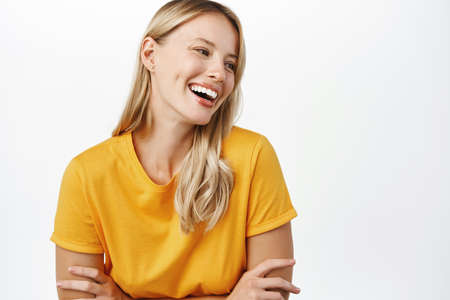 Portrit of beautiful modern woman with natural blond hair, white smile, clear perfect skin, laughing...