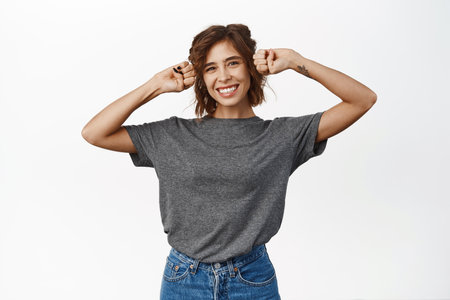 Beautiful happy girl posing silly, showing cute paws gesture and dancing, white studio background isolatedの写真素材